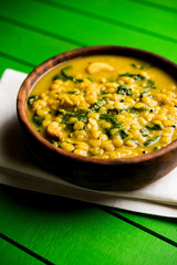 Dal Palak or Lentil spinach curry - popular Indian main course healthy recipe. served in a karahi/pan or bowl. selective focus