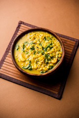 Dal Palak or Lentil spinach curry - popular Indian main course healthy recipe. served in a karahi/pan or bowl. selective focus