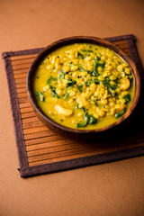 Dal Palak or Lentil spinach curry - popular Indian main course healthy recipe. served in a karahi/pan or bowl. selective focus