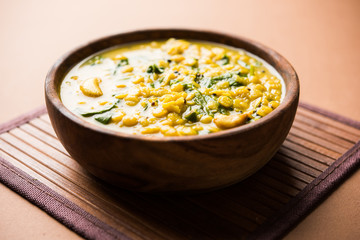 Dal Palak or Lentil spinach curry - popular Indian main course healthy recipe. served in a karahi/pan or bowl. selective focus