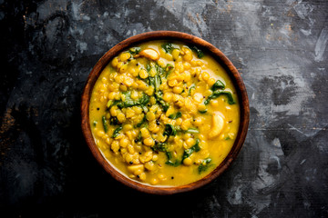 Dal Palak or Lentil spinach curry - popular Indian main course healthy recipe. served in a...