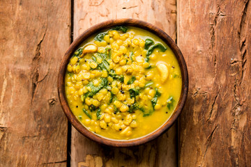 Dal Palak or Lentil spinach curry - popular Indian main course healthy recipe. served in a karahi/pan or bowl. selective focus
