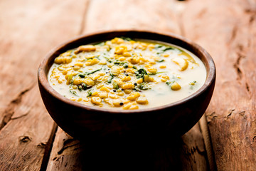 Dal Palak or Lentil spinach curry - popular Indian main course healthy recipe. served in a karahi/pan or bowl. selective focus