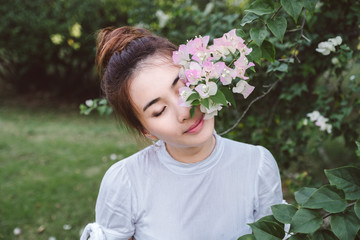 Fototapeta premium Outdoor beautiful young woman surrounded by flowers. Spring blossom