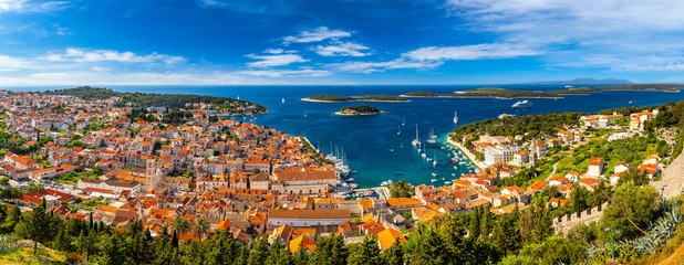 Naklejka premium Panorama view at amazing archipelago in front of town Hvar, Croatia. Harbor of old Adriatic island town Hvar. Amazing Hvar city on Hvar island, Croatia. High resolution photo of Hvar town, Croatia.