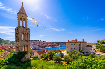 View at amazing archipelago in front of town Hvar, Croatia with seagull's flying over the city. Harbor of old Adriatic island town Hvar. Amazing Hvar city on Hvar island, Croatia. - obrazy, fototapety, plakaty