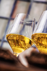 two glasses of wine with factory window background