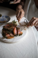People eating good Norwegian cheese, crackers, meats and fish