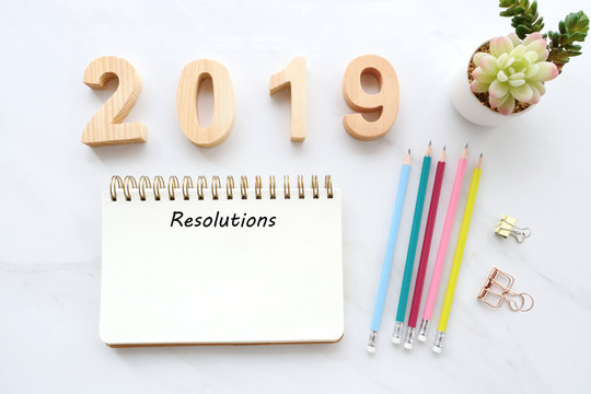 2019 resolution on blank notebook paper on white table background, 2019 new year mock up, template, flat lay