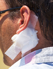 Bandaged wound on a man’s neck