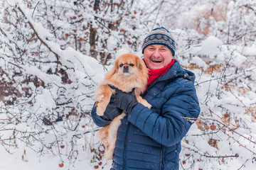 Concept of animals and pets. Best friend ever. Senior man with a dog on a walk 