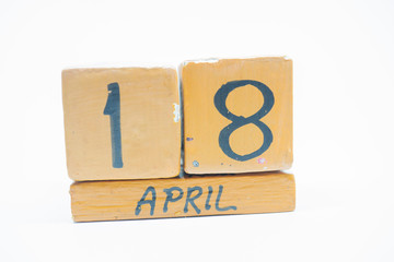 april 18th. Day 18 of month, handmade wood calendar isolated on white background. spring month, day of the year concept.