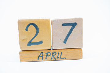 april 27th. Day 27 of month, handmade wood calendar isolated on white background. spring month, day of the year concept.
