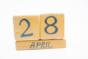 april 28th. Day 28 of month, handmade wood calendar isolated on white background. spring month, day of the year concept.