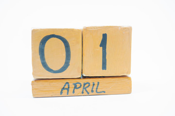 april 1st. Day 1 of month, handmade wood calendar isolated on white background. spring month, day of the year concept.