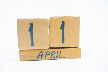 april 11th. Day 11 of month, handmade wood calendar isolated on white background. spring month, day of the year concept.