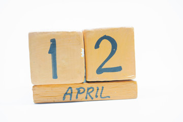 april 12th. Day 12 of month, handmade wood calendar isolated on white background. spring month, day of the year concept.