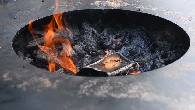 Large fire pit with charcoals close view