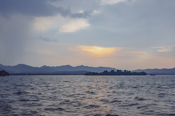 View of islands and hills over West Lake in Hangzhou, China, at sunset