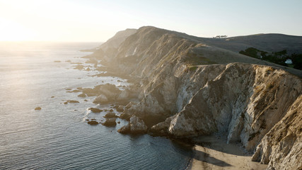 Looking down on a beautiful rocky California coastline at sunset with the ocean below