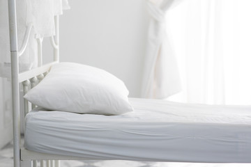 Fototapeta na wymiar empty white bed and pillow in bedroom ready to lying sleep and relax in the morning feeling so comfortable in white room,Sleep Healthcare concept