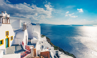 Architecture of Oia village, Santorini island in Greece, on a sunny day with dramatic sky. Scenic travel background.