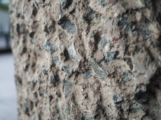 Detail of a rough textured rocky flint stone and cement wall