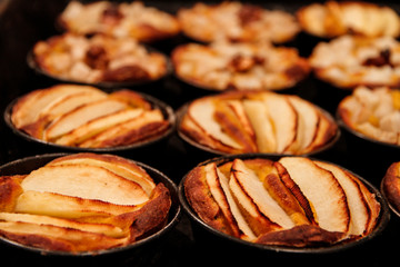 Small homemade apple pies freshly baked each in its mold