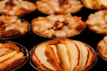 Small homemade apple pies freshly baked each in its mold