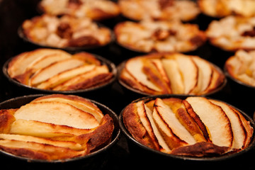 Small homemade apple pies freshly baked each in its mold