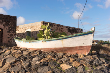 Old wooden fishing boat with cactuses plant. Fuerteventura. Canary Islands. Spain