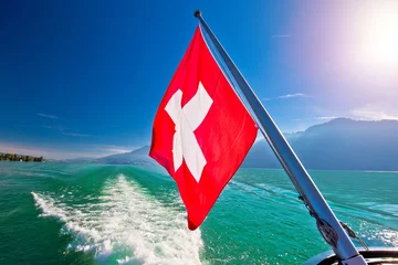 Schilderijen op glas Flowing on idyllic Swiss lake Lucerne boat flag view © xbrchx