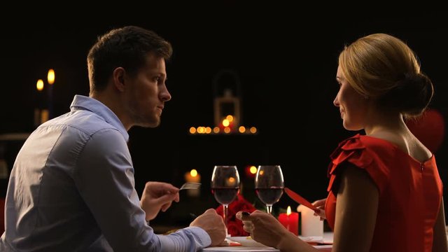 Male and lady having dinner in restaurant tasting red wine, couple on blind date