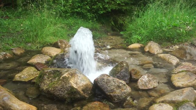 Artesian well. Eruption of spring, natural environment. Stones and water. Clean drinking groundwater erupting out of the ground. Norra Spring Area, Oostriku River, Endla Nature Reserv, Estonia, Europe