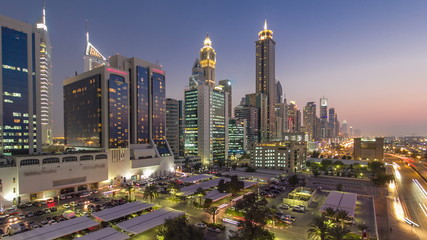 Fototapeta na wymiar Downtown Dubai towers day to night timelapse. Aerial view of Sheikh Zayed road with skyscrapers after sunset.