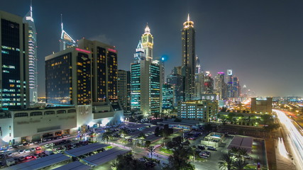 Fototapeta premium Downtown Dubai towers day to night timelapse. Aerial view of Sheikh Zayed road with skyscrapers after sunset.
