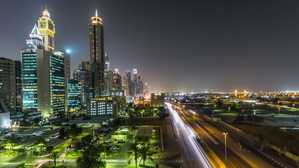 Fototapeta na wymiar Downtown Dubai towers night timelapse. Aerial view of Sheikh Zayed road with skyscrapers.