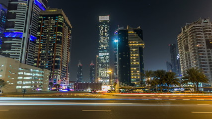 Fototapeta na wymiar Downtown Dubai towers night timelapse hyperlapse. View of Sheikh Zayed road with tall skyscrapers.