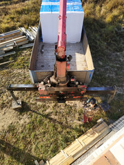 unloading of blocks by automobile crane on the construction site