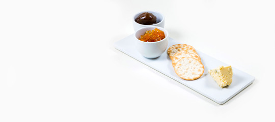 Cheese and Crackers on a white plate on a white background isolated