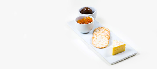 Cheese and Crackers on a white plate on a white background isolated