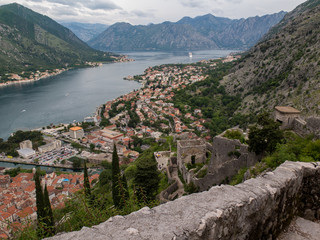 Fortification walls in the ancient city of Kotor, looking down on the orange terracotta roofs