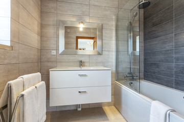 Modern bathroom with shower and washbasin for hygiene.