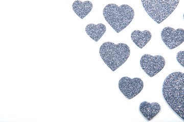 Valentine's Day, silver and red hearts on a white background with empty space