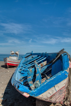 Small fishing boats stranded on the beach of Oued Laou, a village in the province of Chefchaouen on the Mediterranean coast of Morocco.