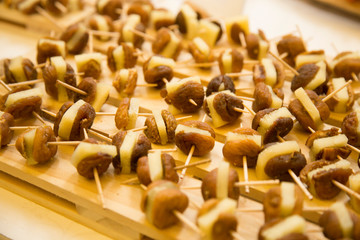 horizontal image with detail of fruit skewers with figs and cheese