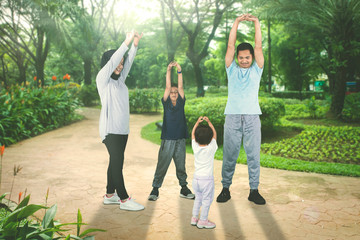 Muslim family doing warm up before exercising
