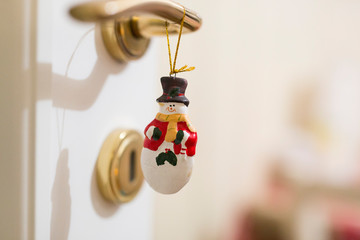 horizontal image with detail of a nice Christmas decoration hanging from a wardrobe key