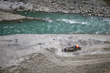 People working on the bank of a river in Nepal