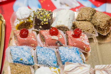 horizontal image with a close-up detail of typical Moroccan pastries of various kinds served on a tray